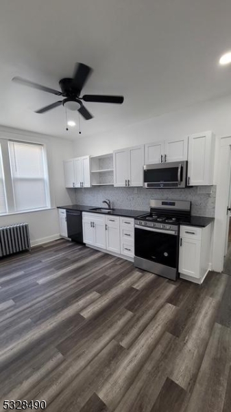 a large kitchen with stainless steel appliances granite countertop a stove and a sink