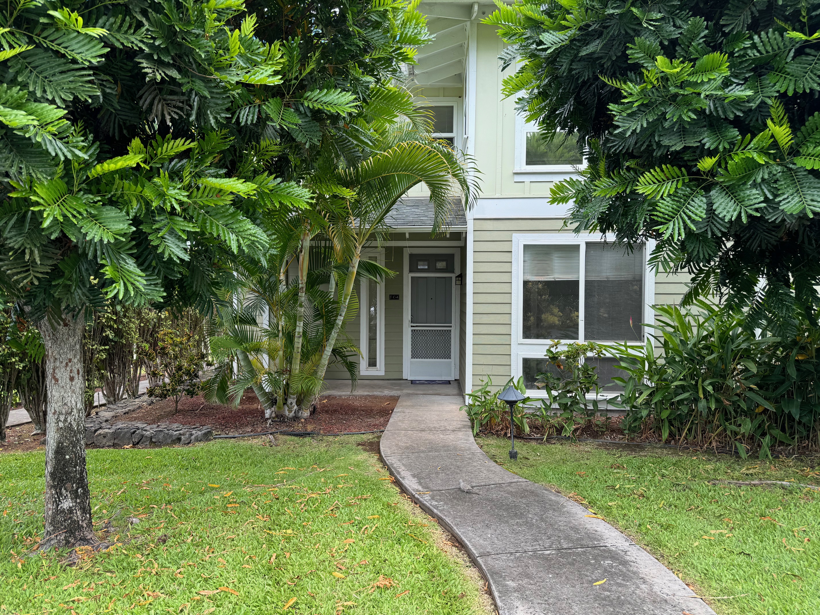 a front view of a house with garden