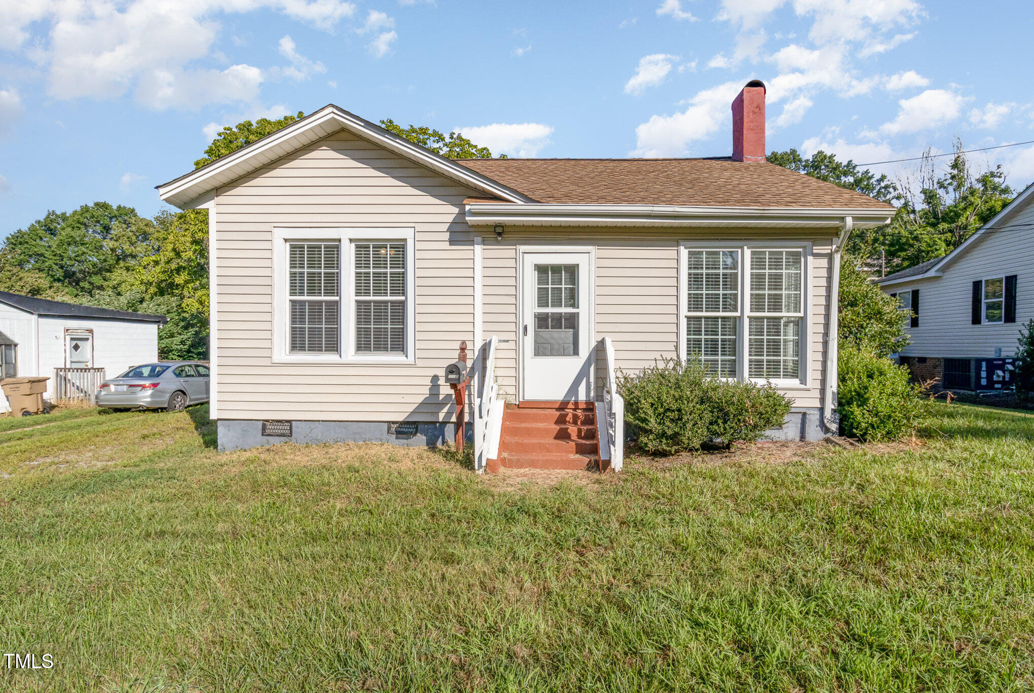 a front view of a house with garden and porch