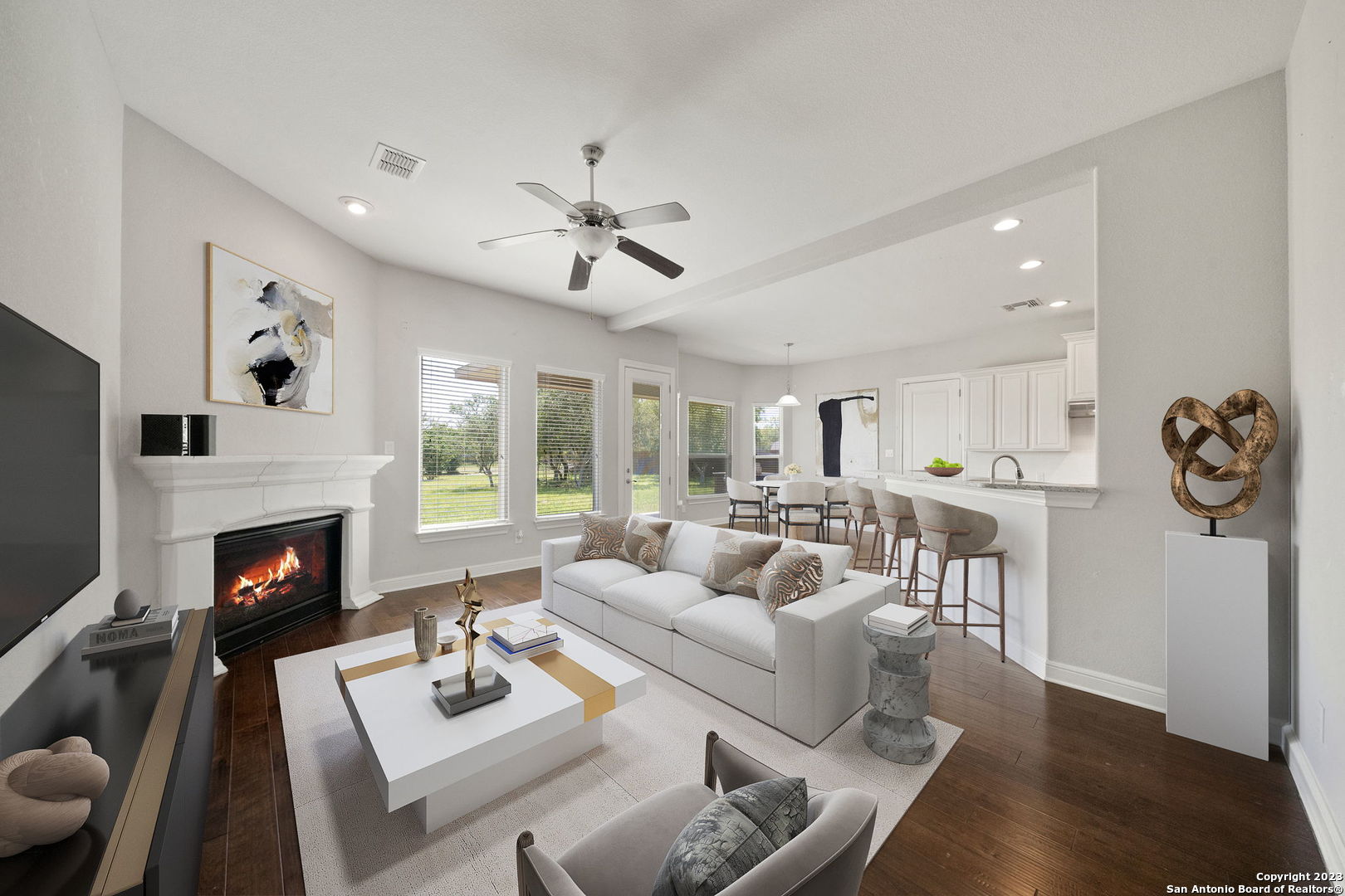 a living room with furniture fireplace and window