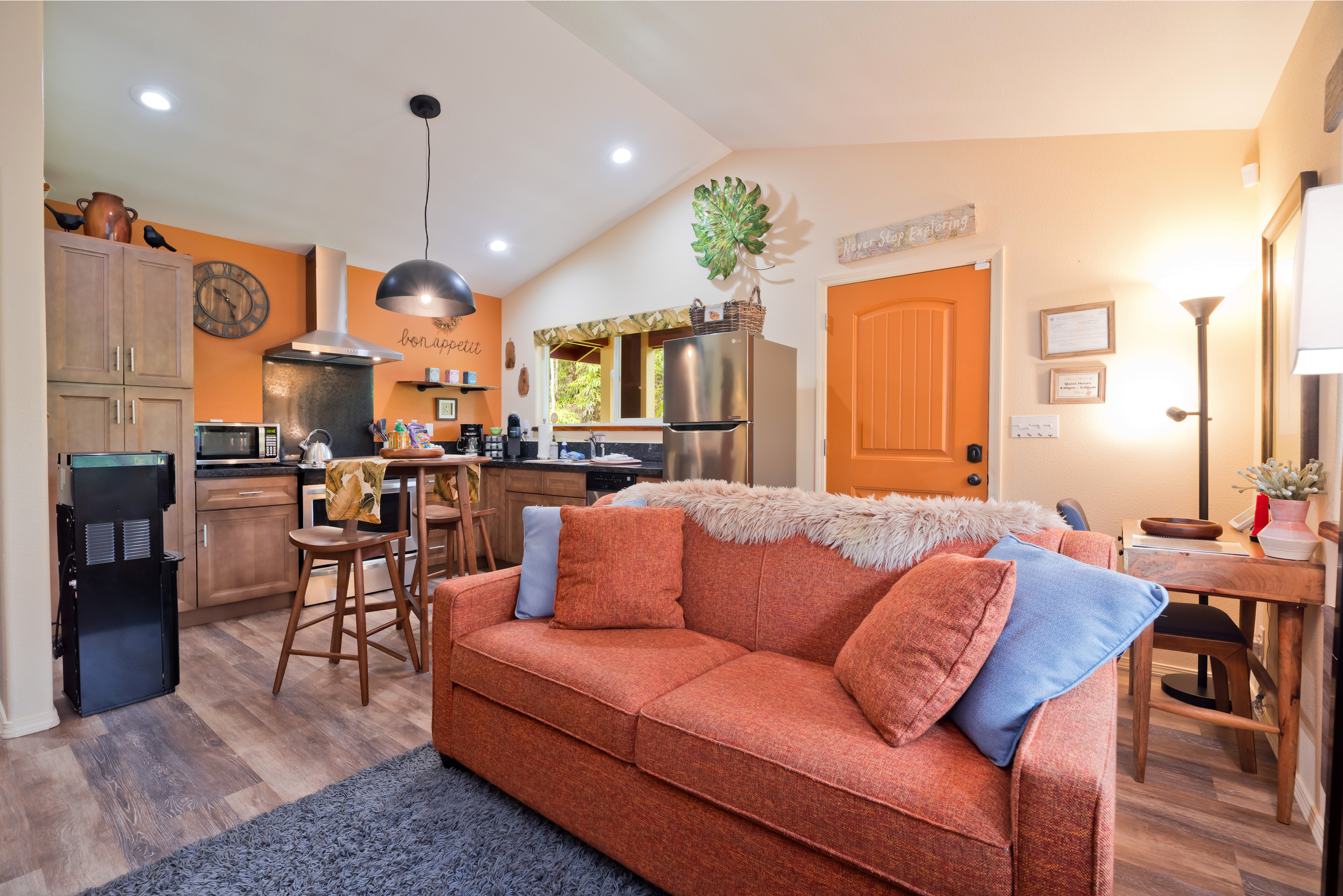 a living room with furniture kitchen view and a large window