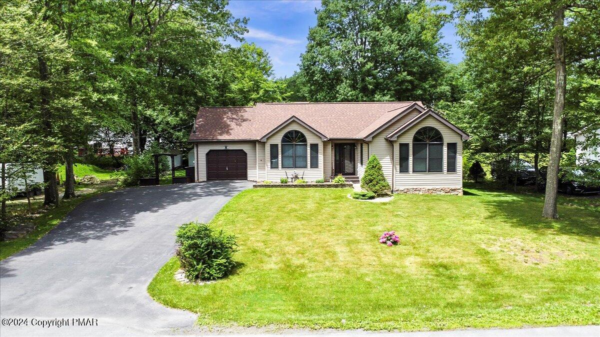 a front view of a house with garden