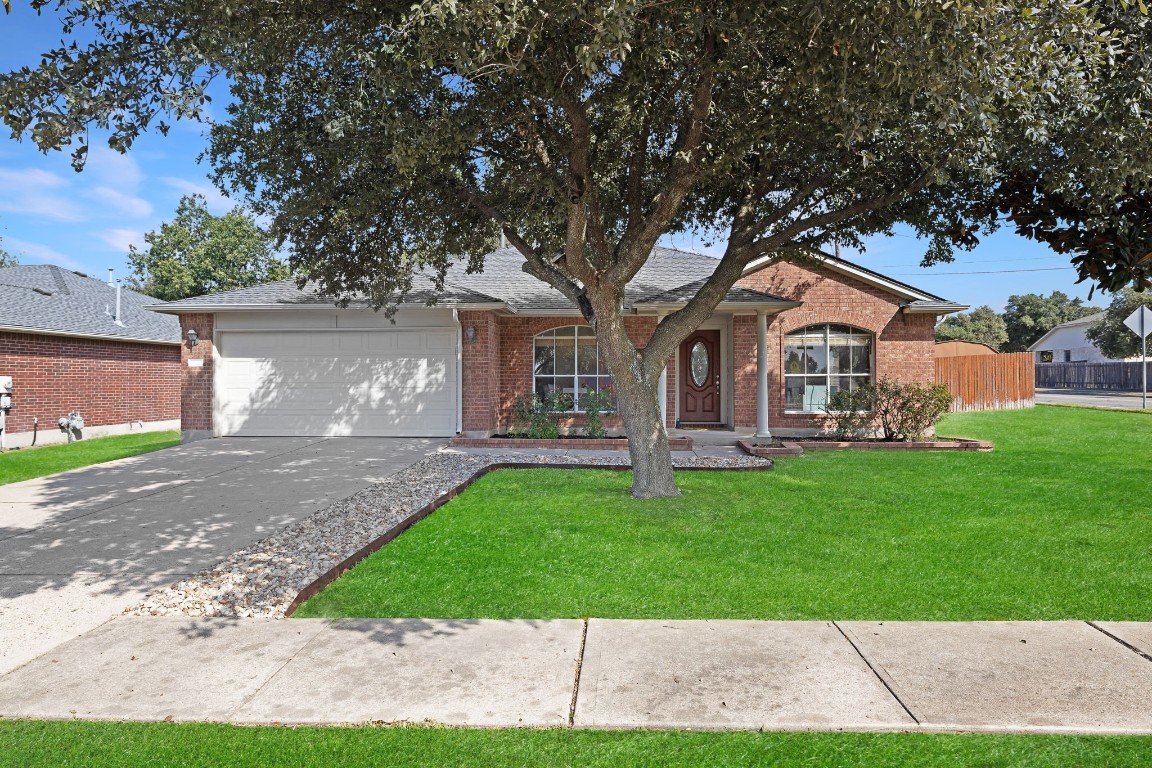 a front view of a house with a garden and yard