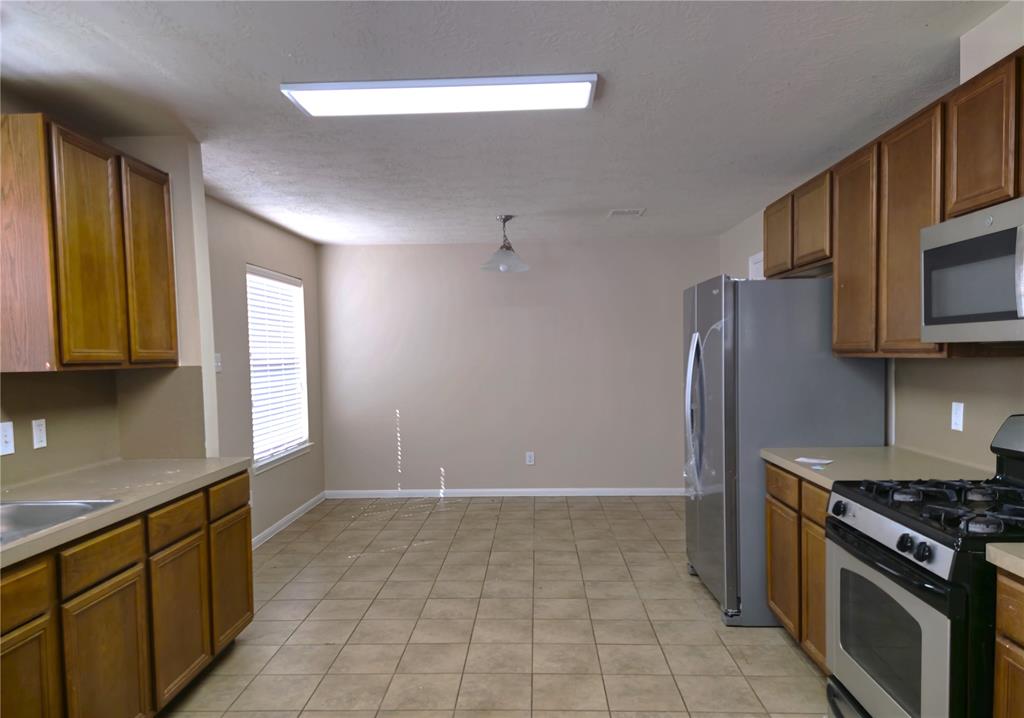 a kitchen with granite countertop a stove and a sink