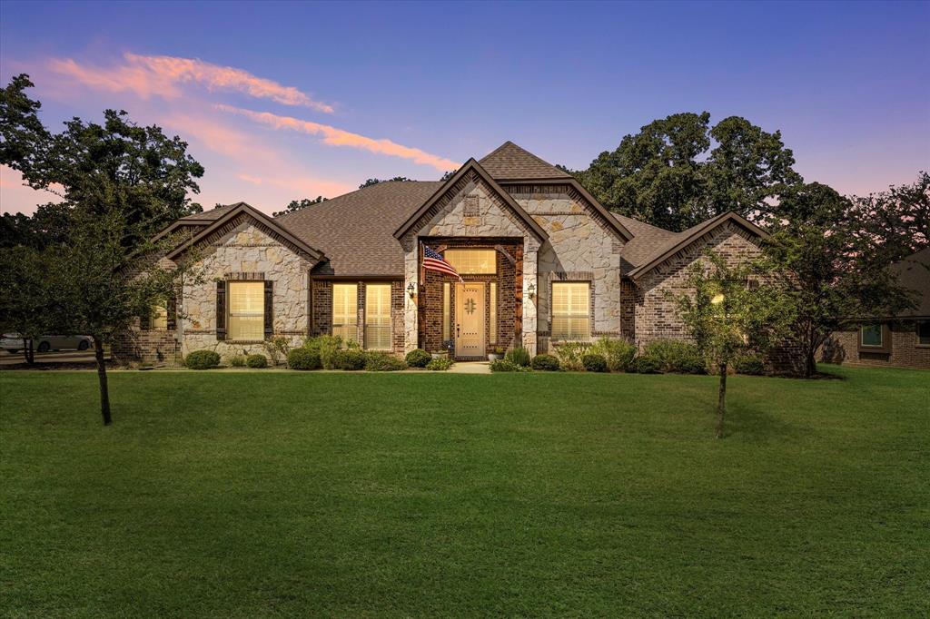 a front view of a house with a yard