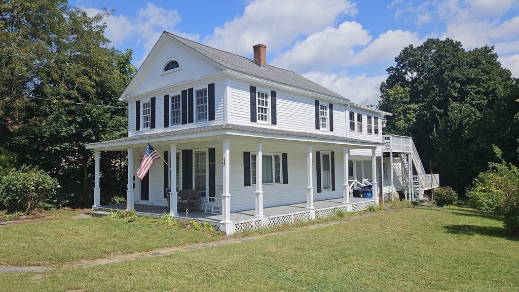 a view of a house with a yard and plants