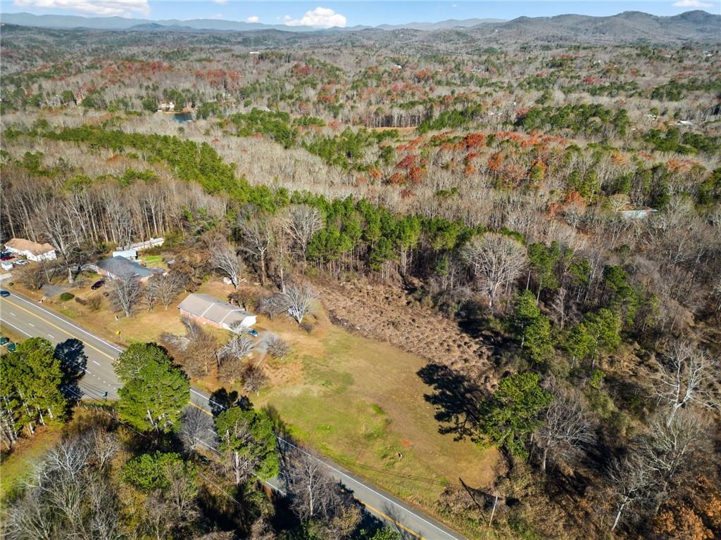 an aerial view of residential house with beach and mountain view