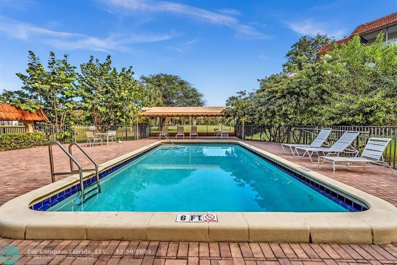 a view of a swimming pool with an outdoor seating