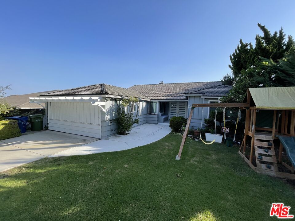 a view of a house with a yard porch and sitting area