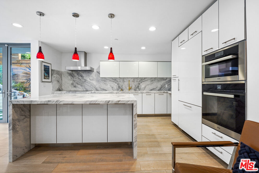 a kitchen with stainless steel appliances granite countertop a sink and cabinets