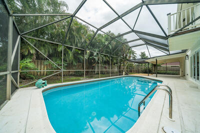 a view of a swimming pool with a deck and wooden floor