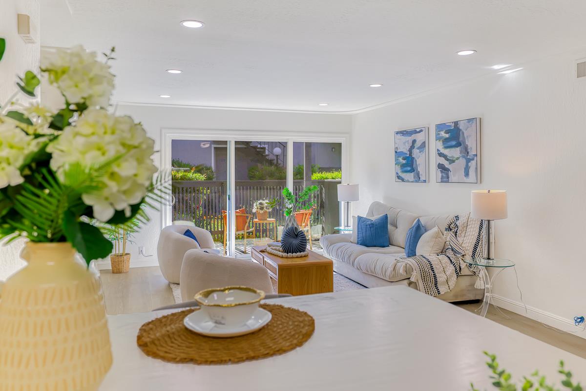 a living room with furniture and a potted plant