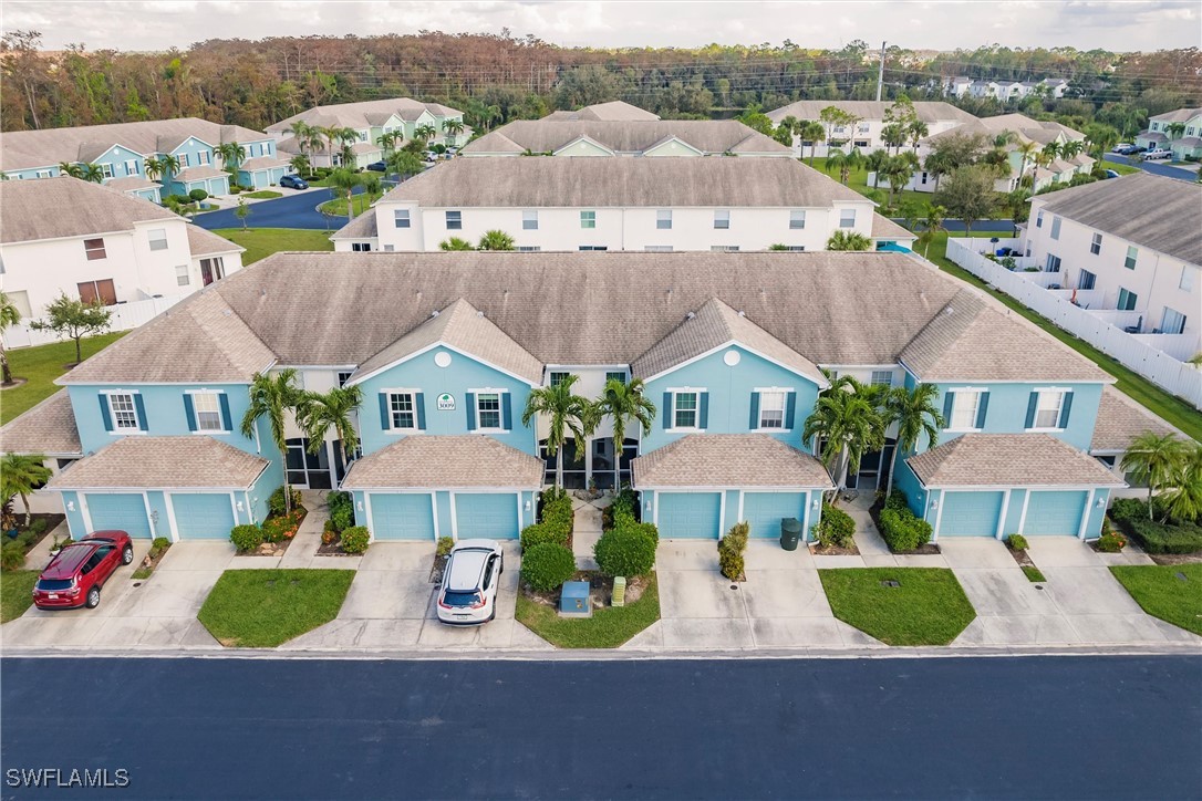 an aerial view of multiple houses with yard