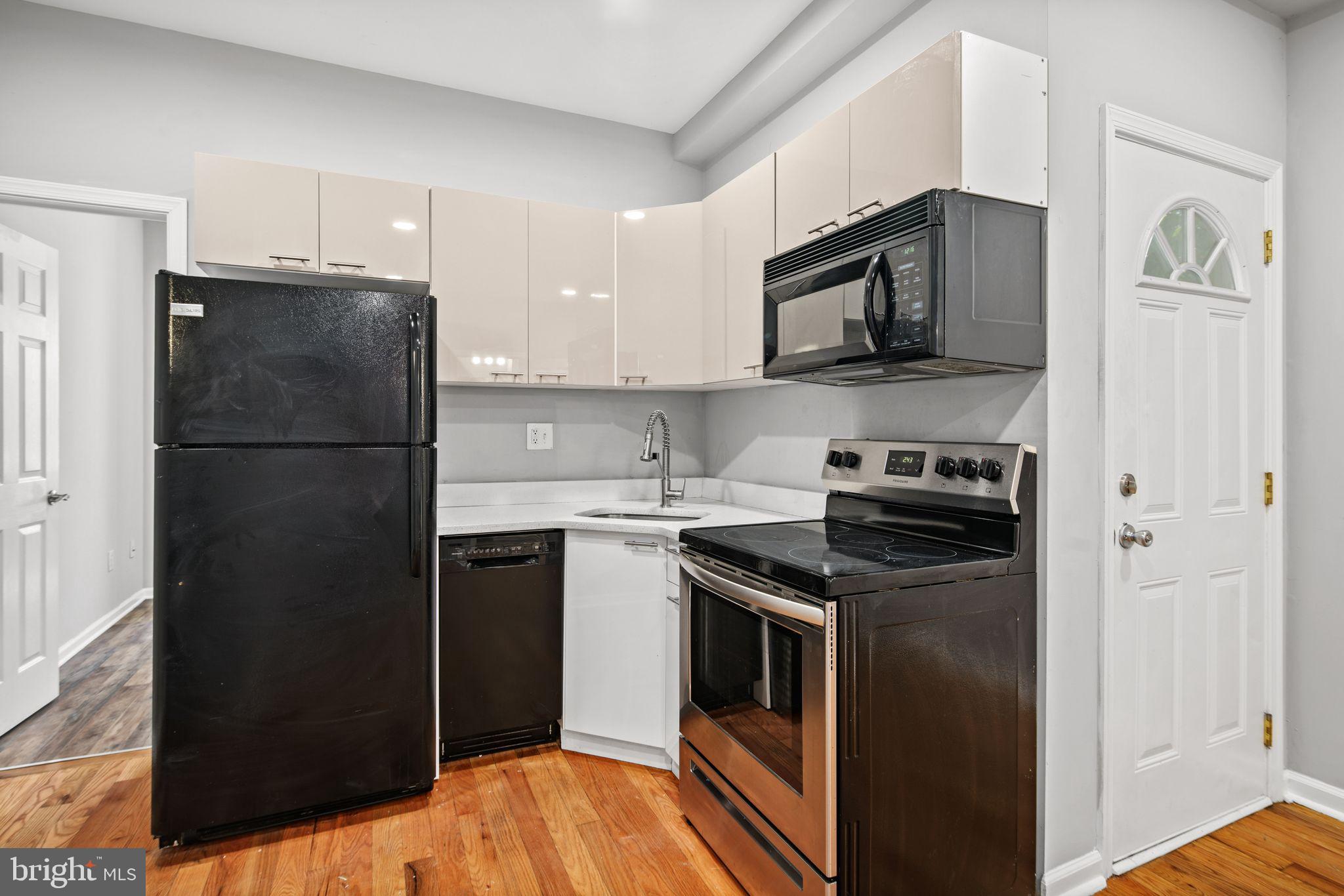 a kitchen with stainless steel appliances granite countertop a refrigerator stove and sink