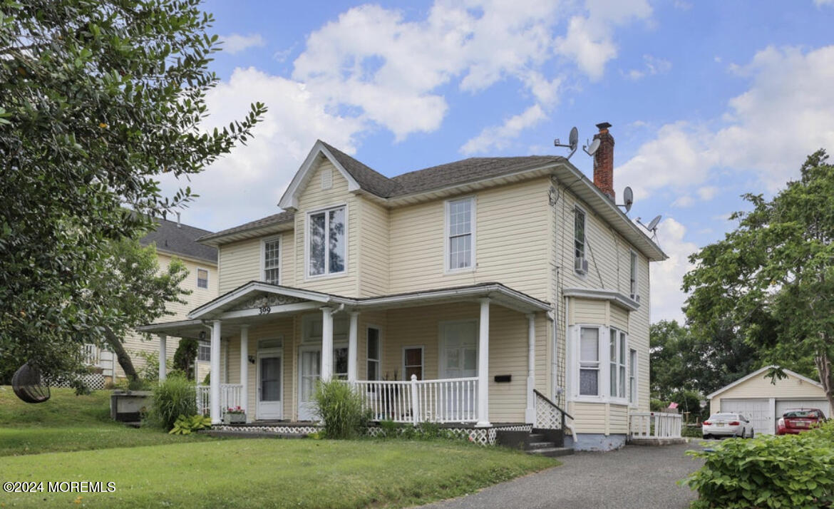 a front view of a house with a garden and plants