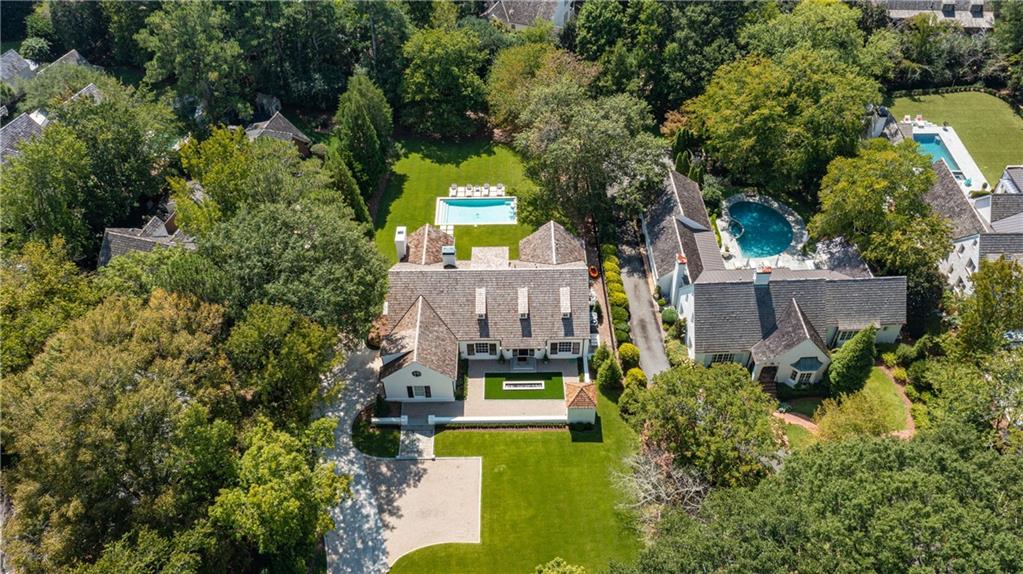 an aerial view of a house with a yard swimming pool and outdoor seating