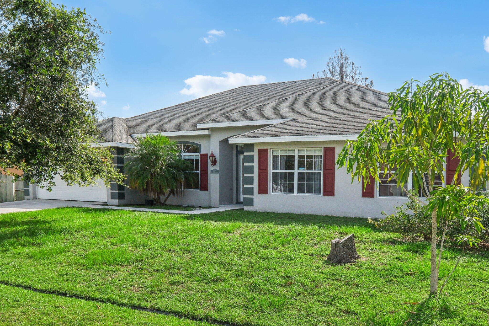 a view of a house with a yard and a garden