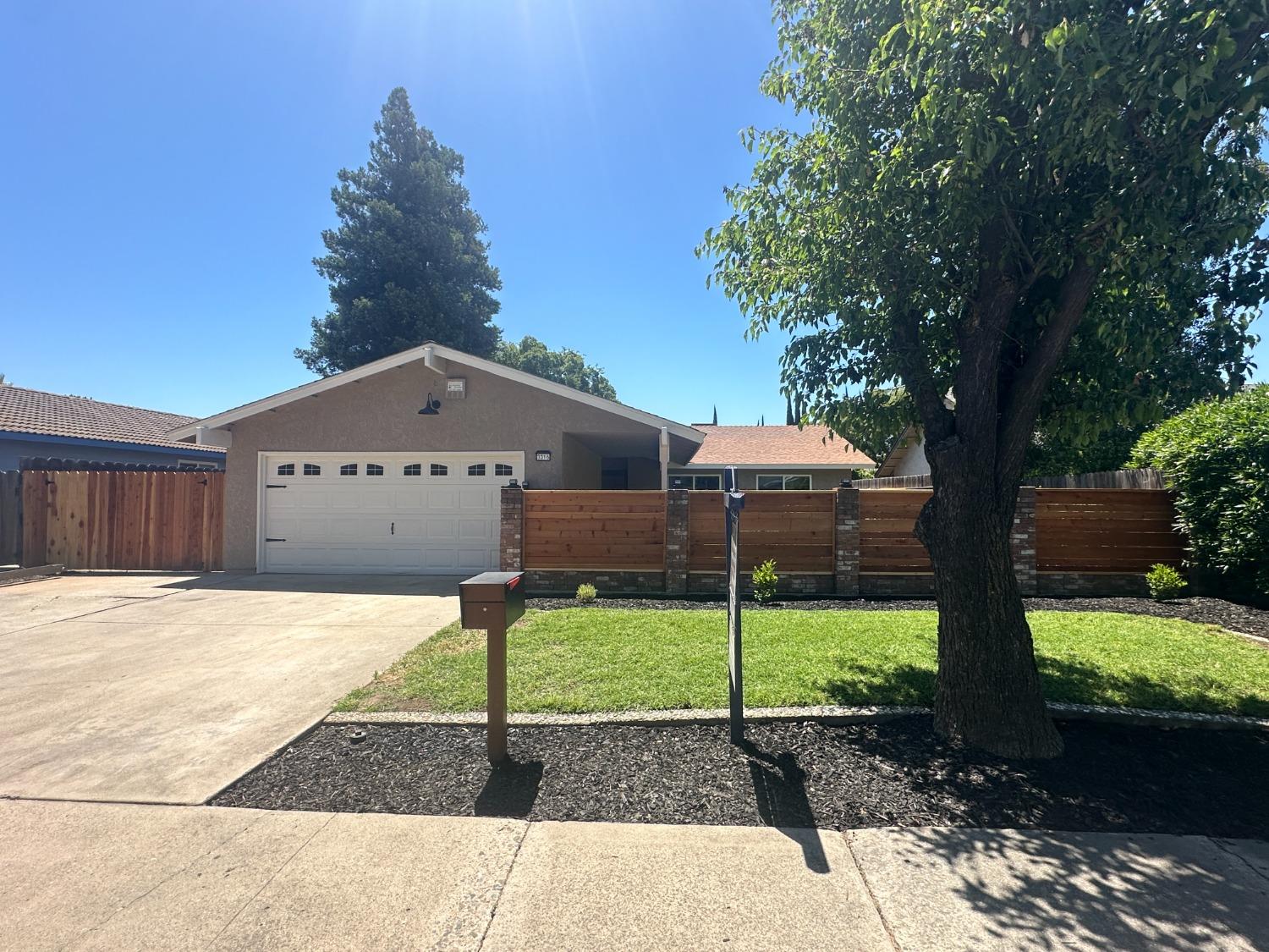 Beautiful curb appeal with new paint, mailbox, and courtyard fence.  Also, notice new double gate on the left for boat or trailer storage.