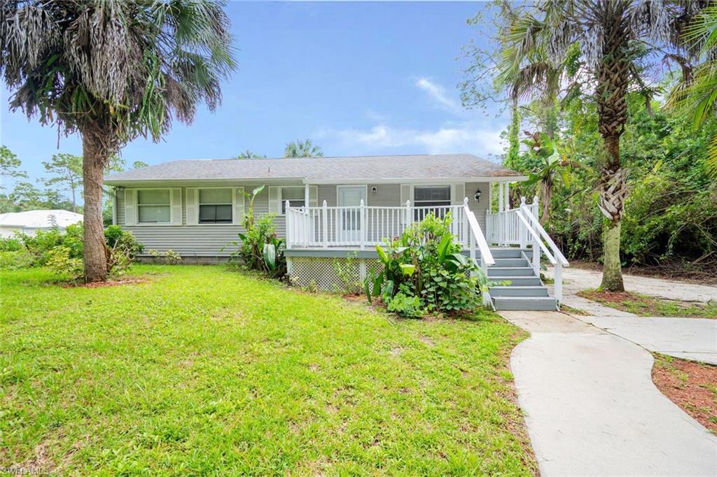 a front view of house with yard and green space