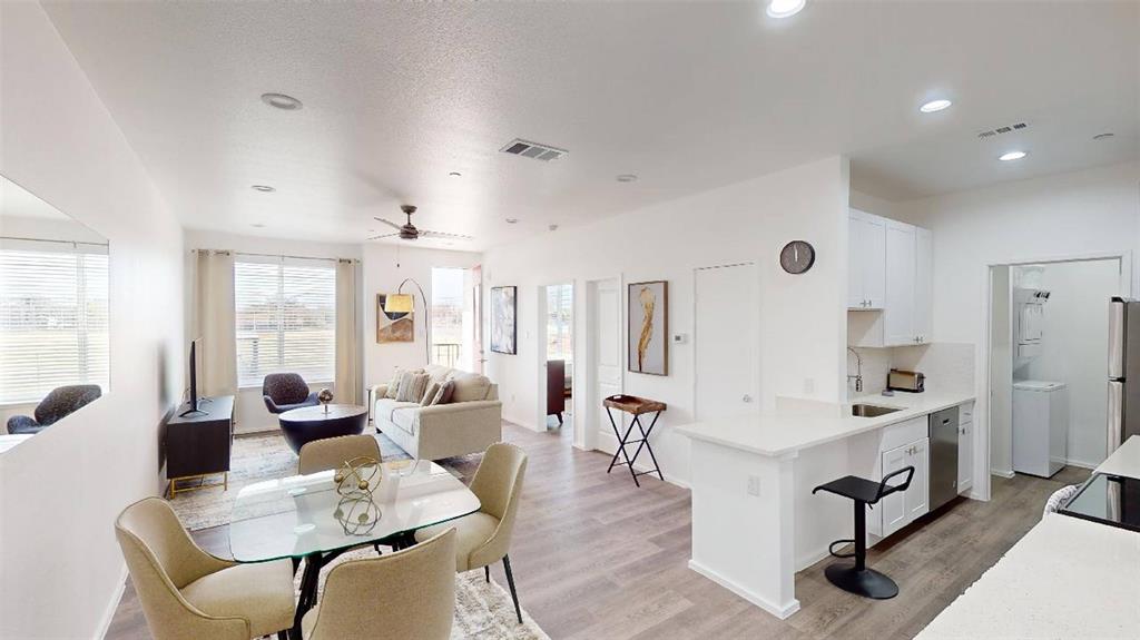 a living room with furniture a rug and white walls