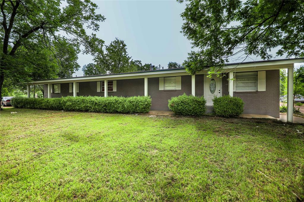 front view of a house next to a yard