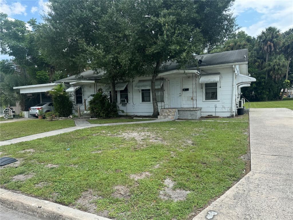 a front view of house with yard and green space