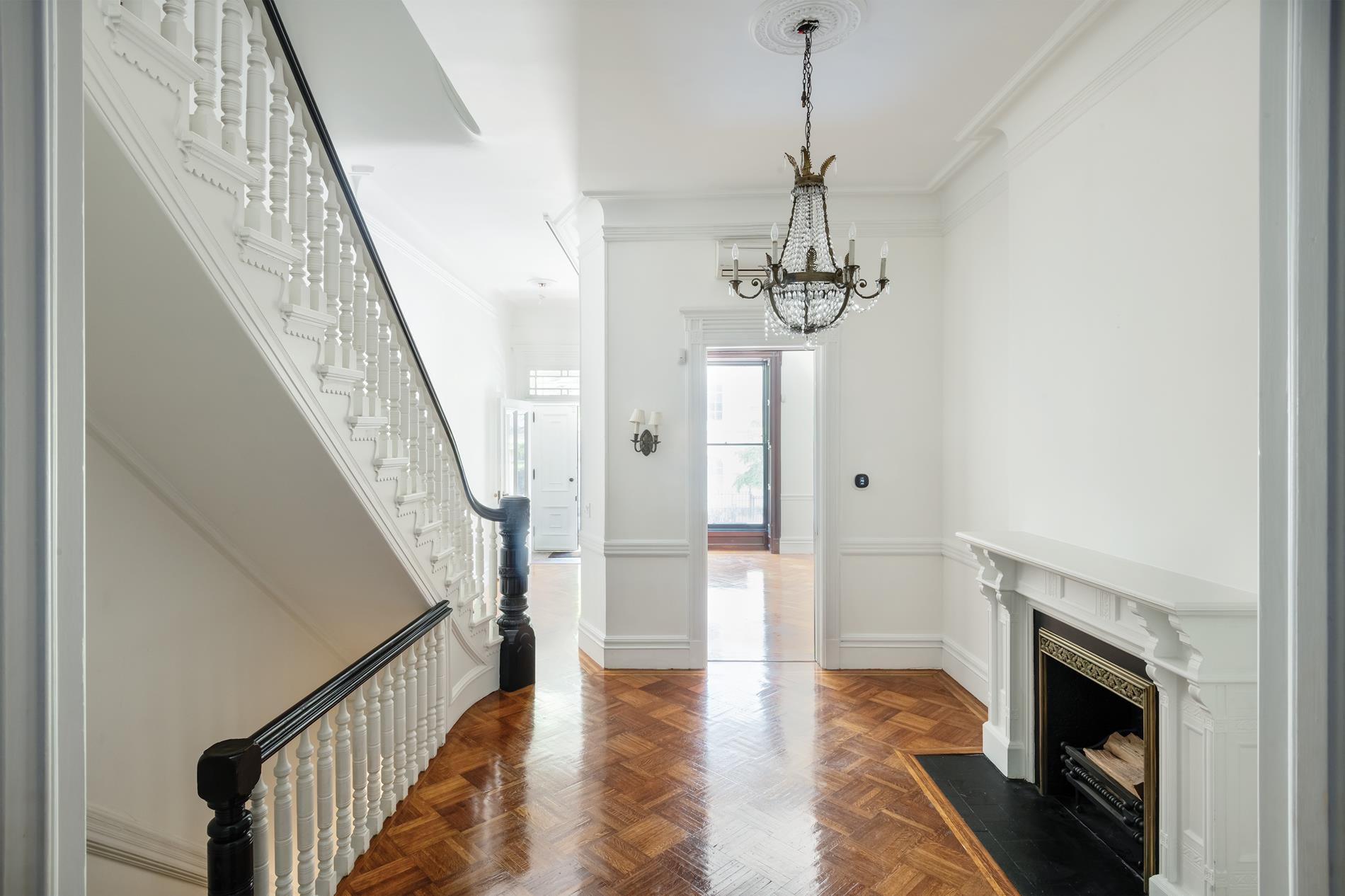 a view of entryway and hall with wooden floor