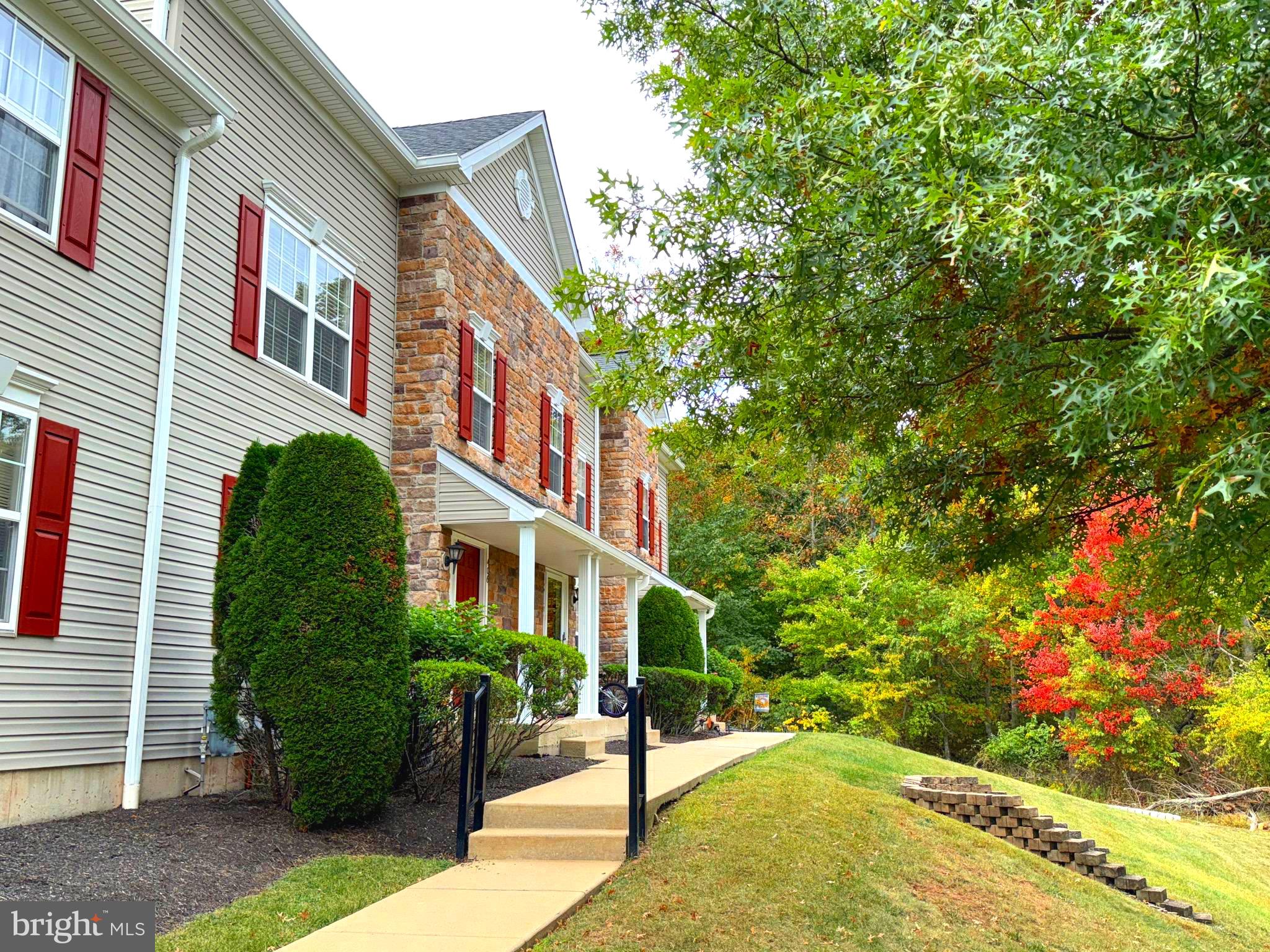 a view of a brick house with a yard