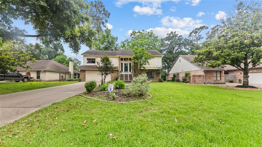 a front view of house with yard and green space