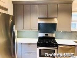 a kitchen with granite countertop a stove and a refrigerator