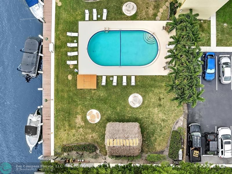 an aerial view of a house with a swimming pool and garden