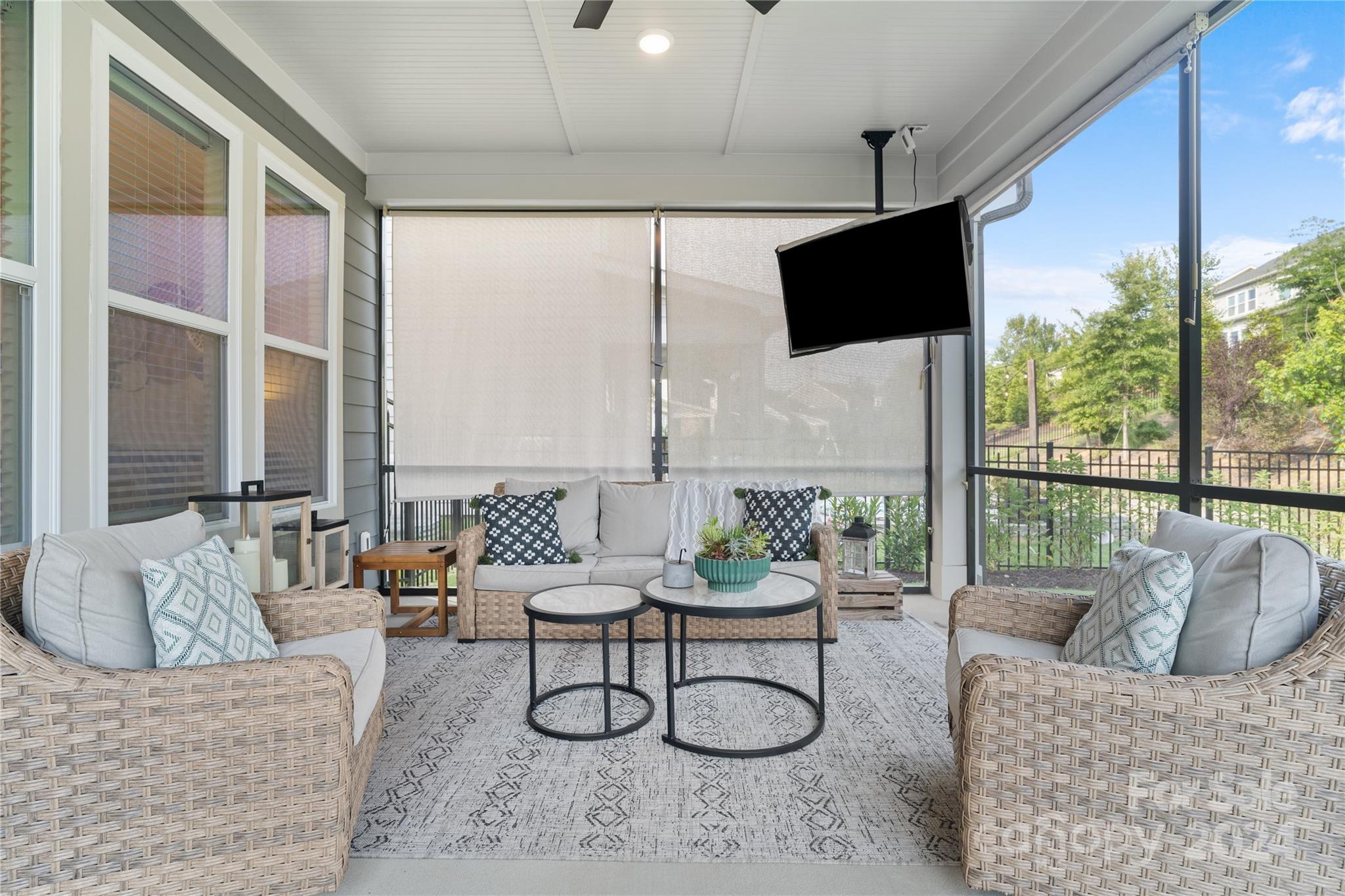 a living room with furniture tv and a large window