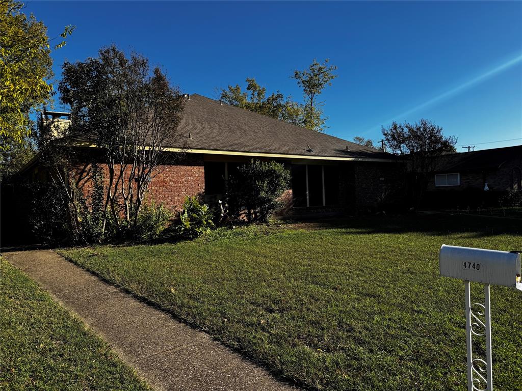 a front view of house with a garden