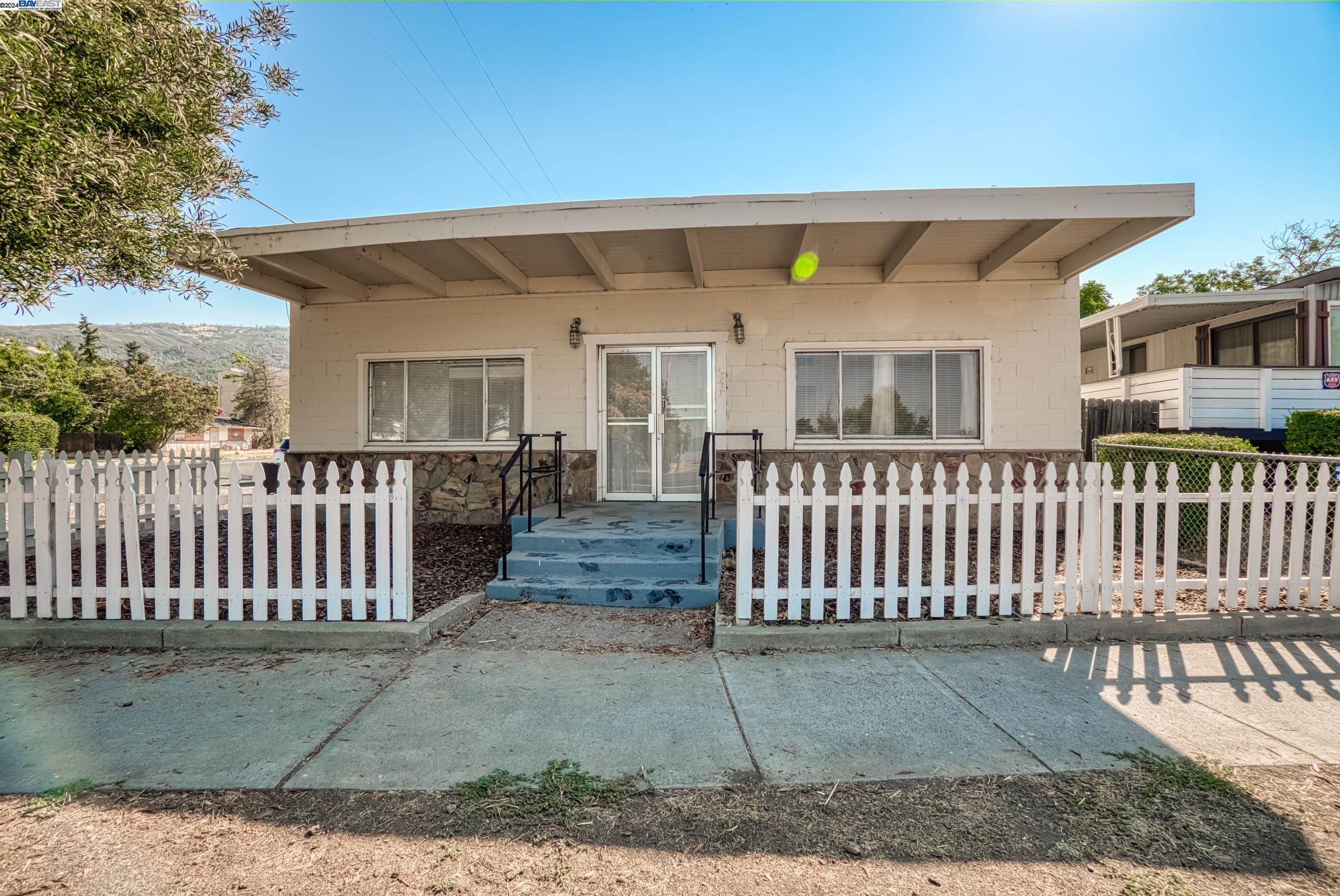 a view of a house with a wooden deck