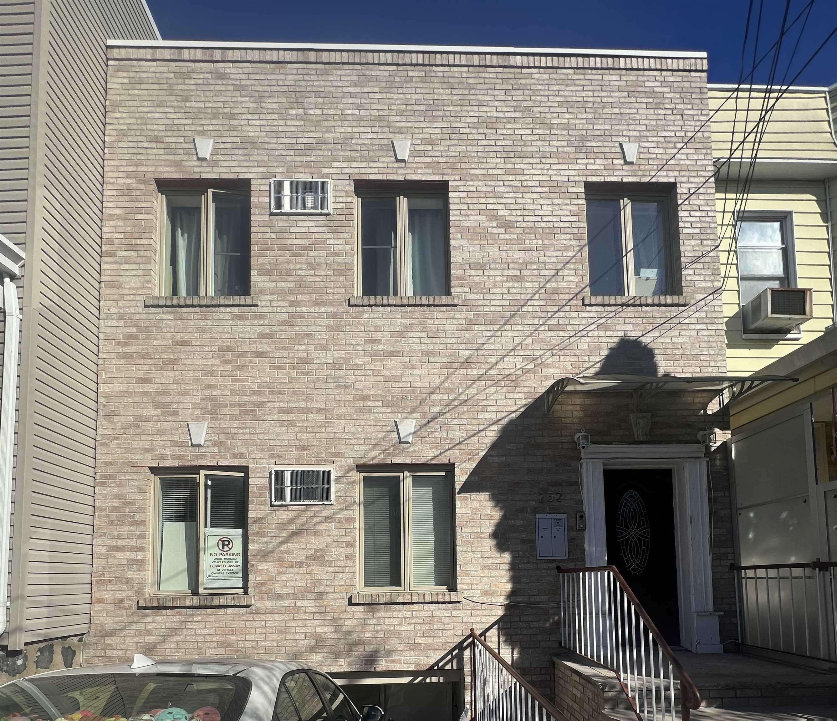 a front view of a house with a brick wall