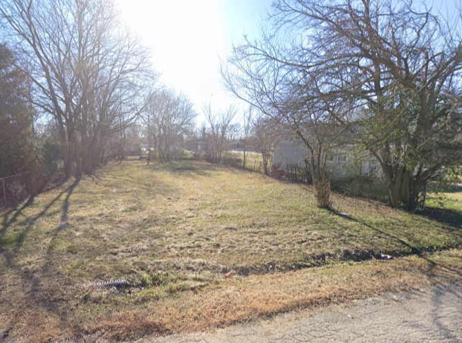 a view of a yard with a tree