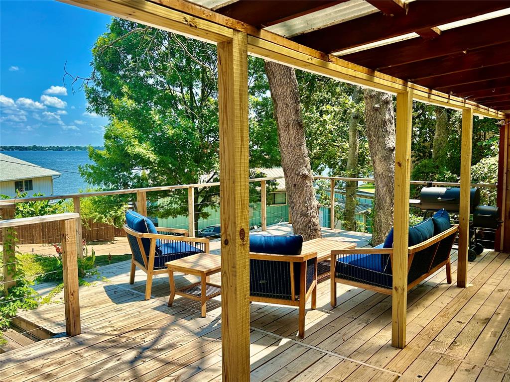 a view of a patio with table and chairs and wooden floor