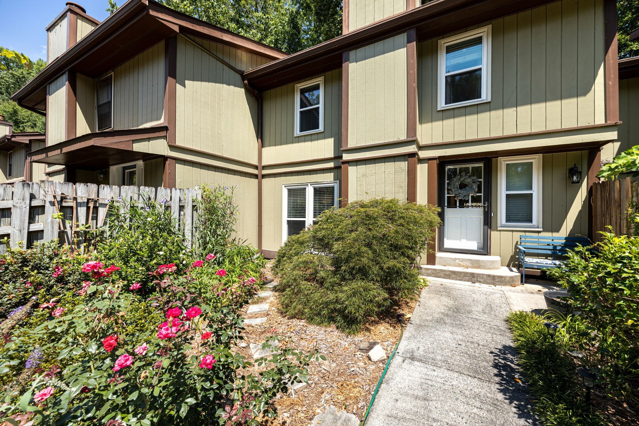 a flower garden is sitting in front of a house