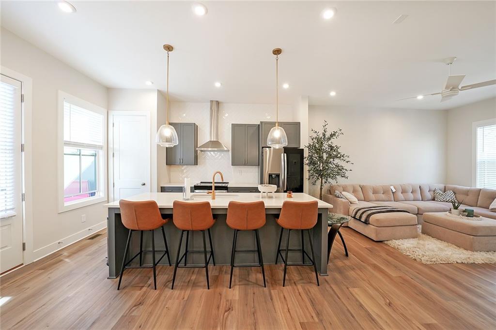 a large kitchen with a table and chairs