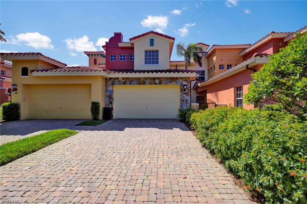 a front view of a house with a yard and a garage