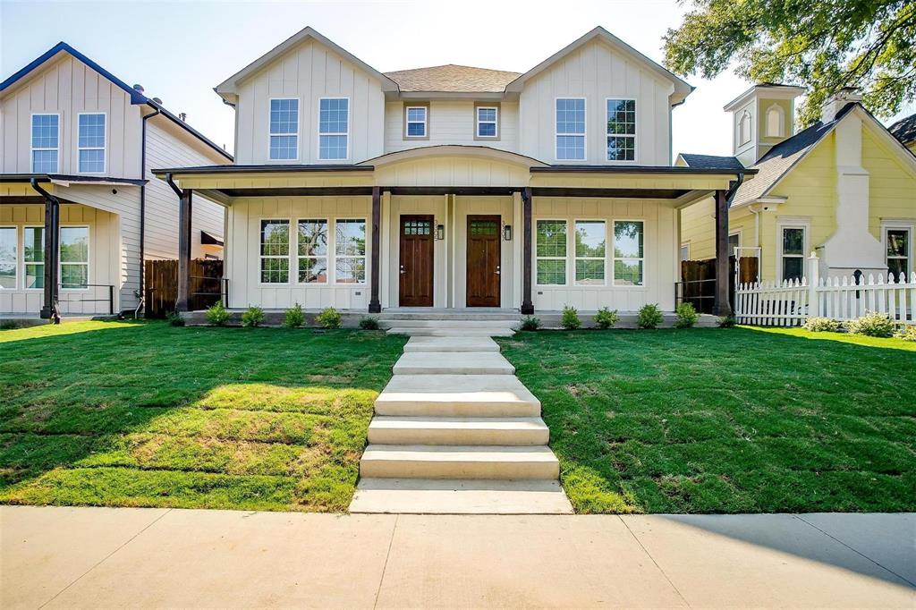 a front view of a house with a yard and porch