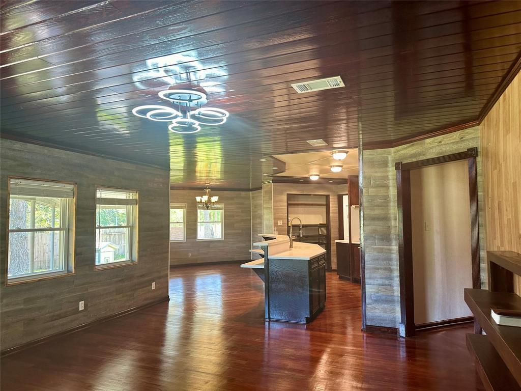 a view of a livingroom with furniture wooden floor and windows