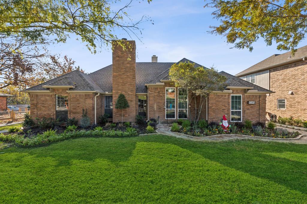 a front view of a house with a yard and outdoor seating