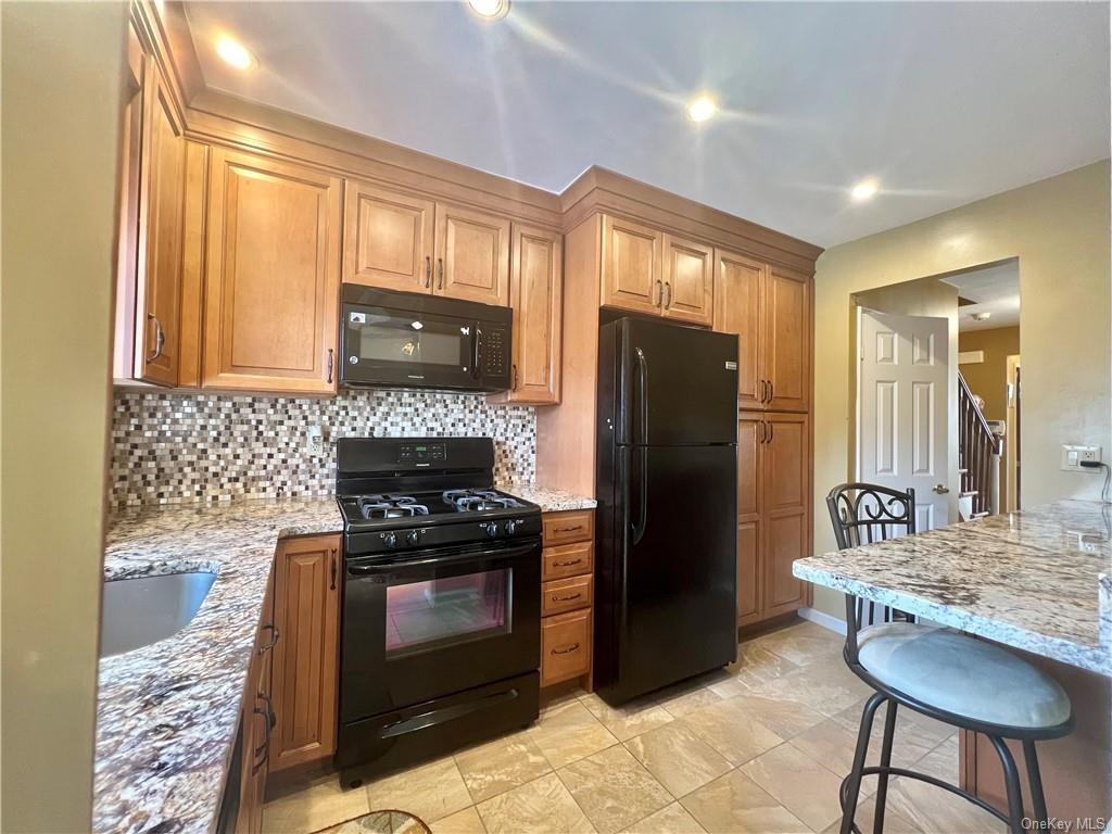 a kitchen with a stove a refrigerator and a stove