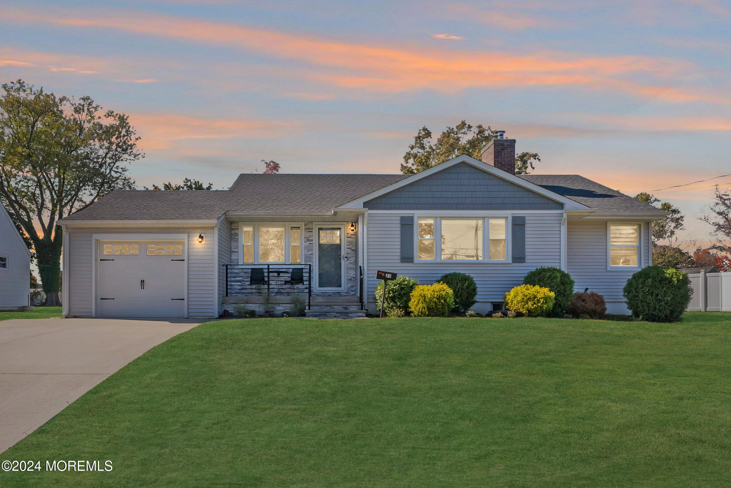 a front view of a house with a garden and yard