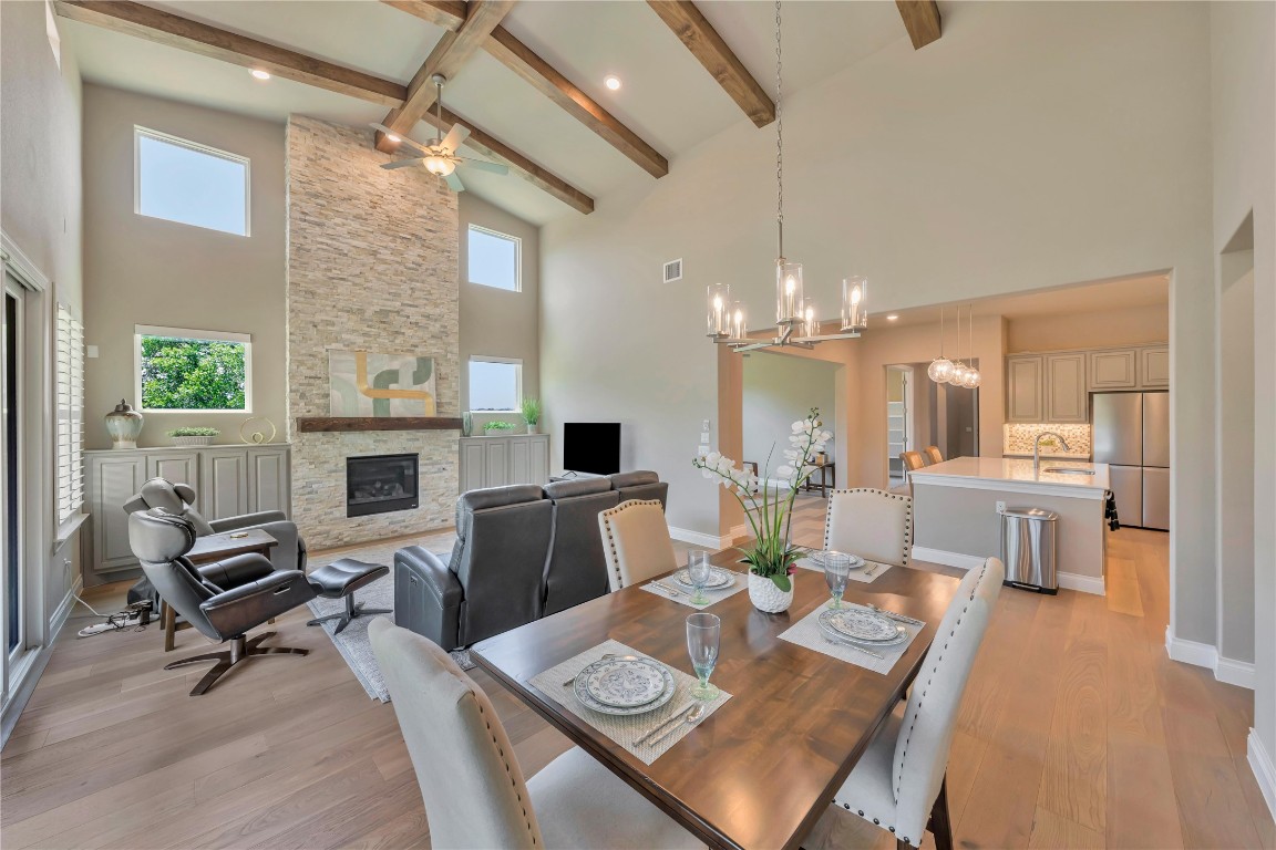 a view of a dining room with furniture a chandelier and wooden floor