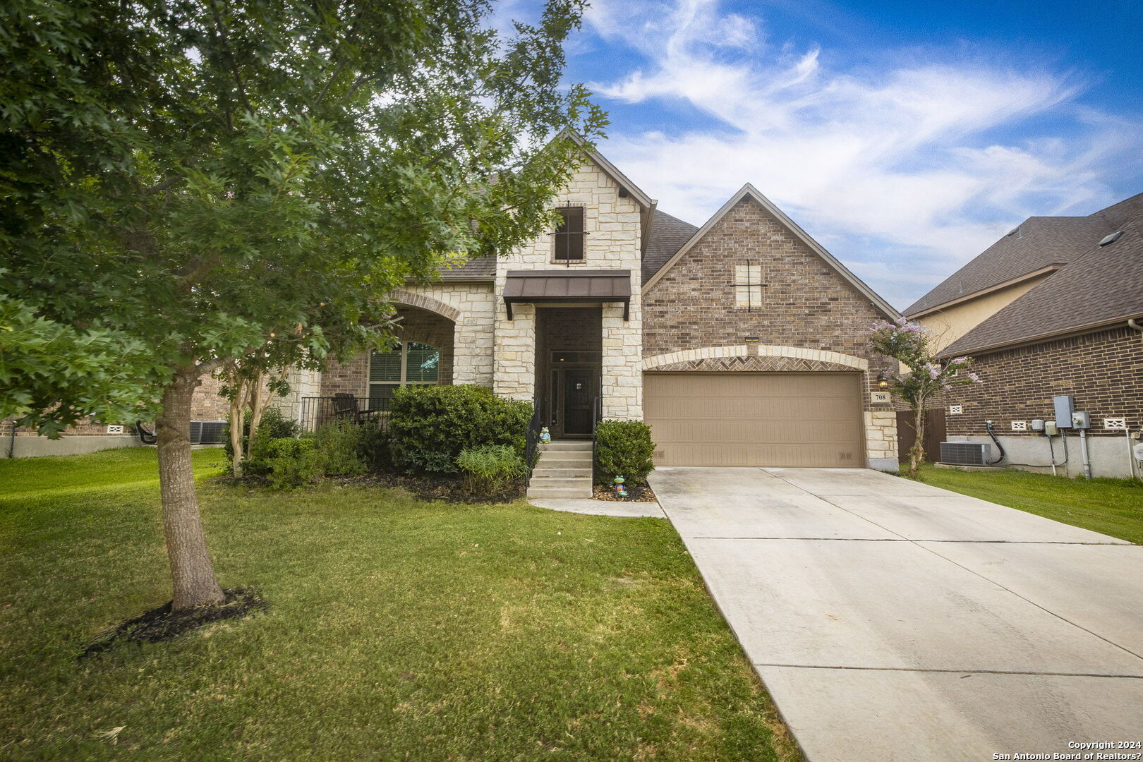 a front view of a house with a yard and garage