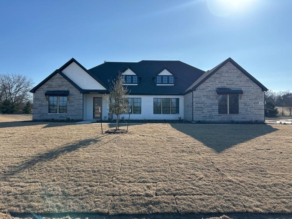 a front view of a house with yard