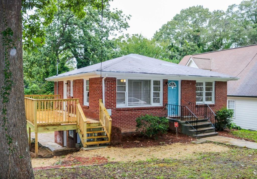 a view of a house with a yard and furniture