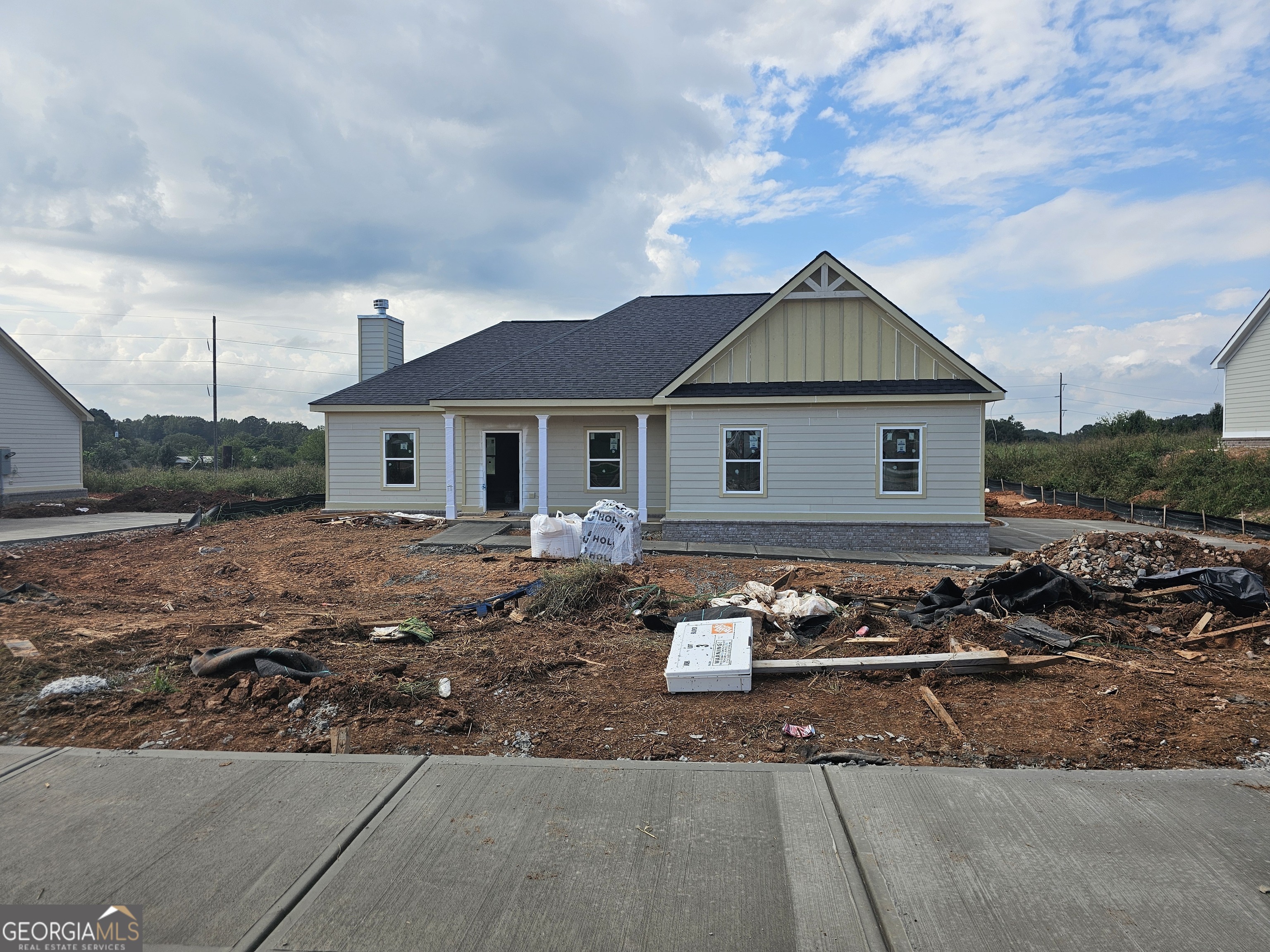 a front view of house with yard outdoor seating and barbeque oven